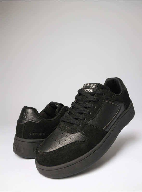 Zapatilla urbana unisex negra de material sintético, ideal para uso diario y resistente al desgaste.